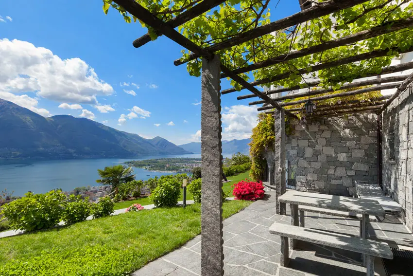 Unobstructed view of the scenic lakeside from a pergola with natural stone posts