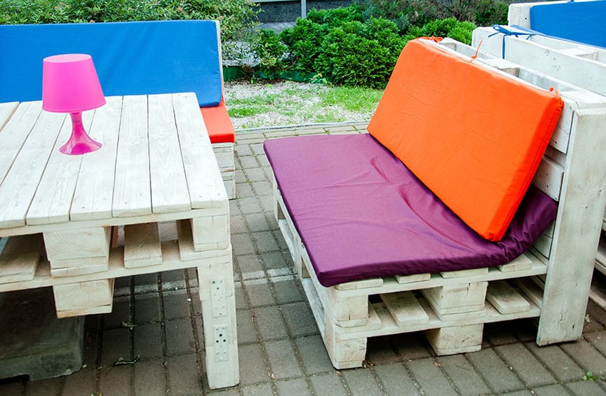 Wood pallet table and chairs with colorful cushions