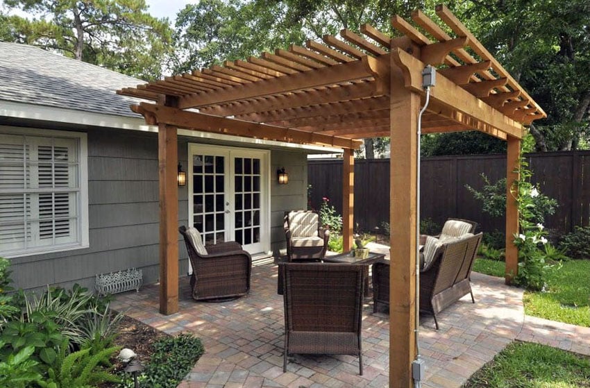 wood pergola kit on small paver patio