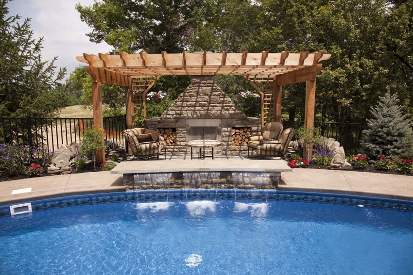Wood pergola overlooking swimming pool with water features