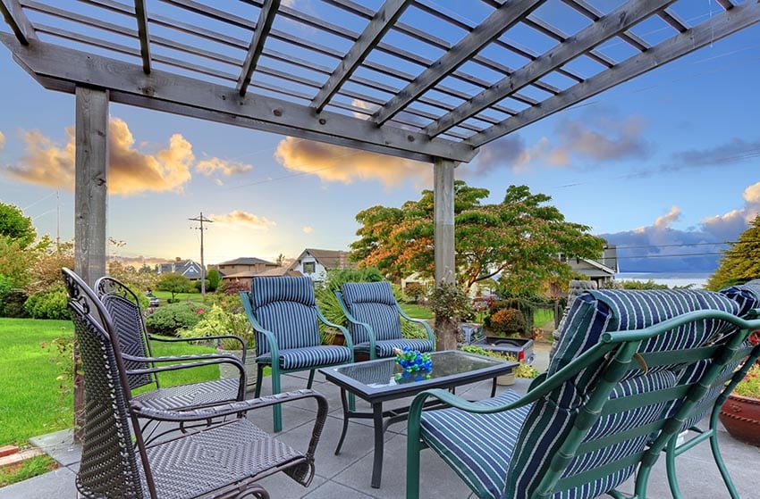 Pergola with cushioned outdoor furniture