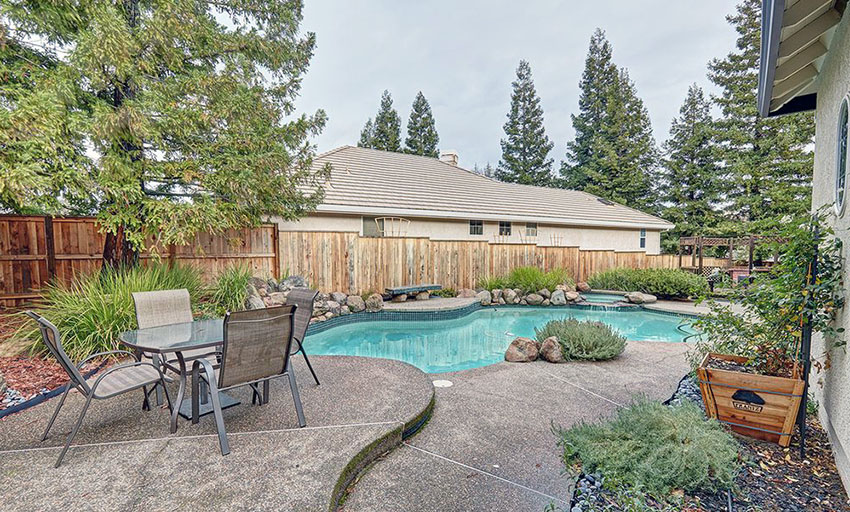 Wood style fence in a backyard patio with pool