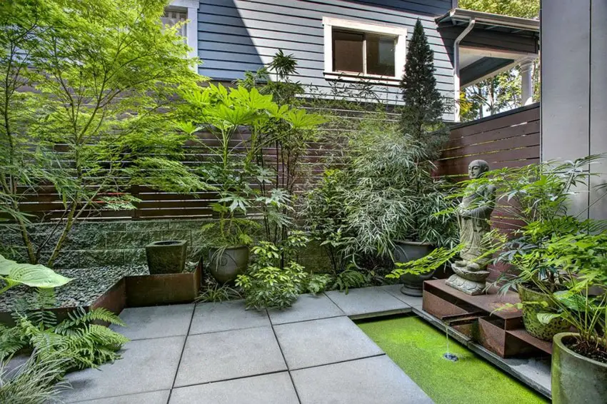 Asian style patio with concrete and horizontal fence