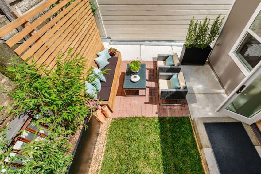 Backyard brick patio with horizontal wood privacy fence
