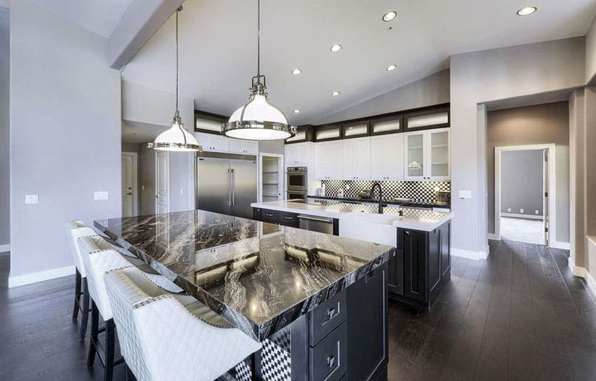 Contemporary kitchen with Agatha black granite countertops, two islands, white cabinets and blackened hickory flooring 