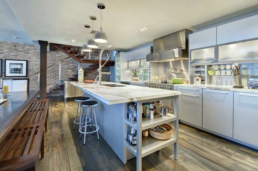 Kitchen with calacatta marble countertop island white cabinetry and wood floors