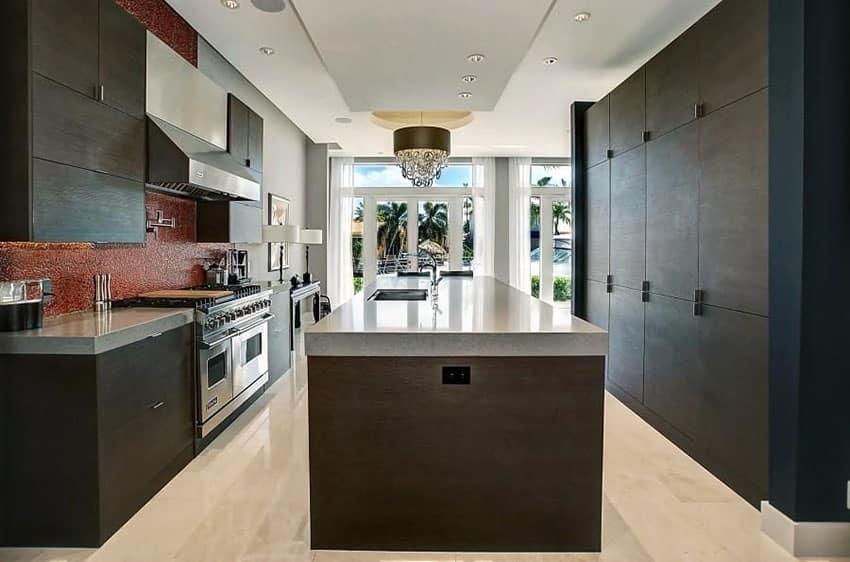 kitchen with dark cabinets gray quartz and large center sink island