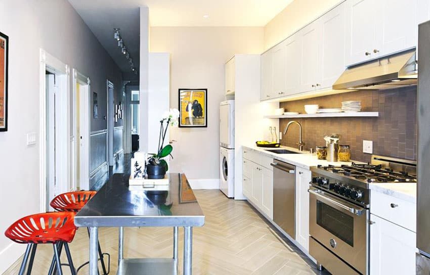 Contemporary kitchen with white cabinets carrara marble counter and stainless steel portable island