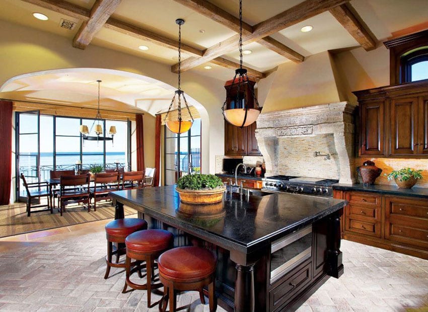 Craftsman kitchen with dark wood cabinetry island and custom stone oven surround