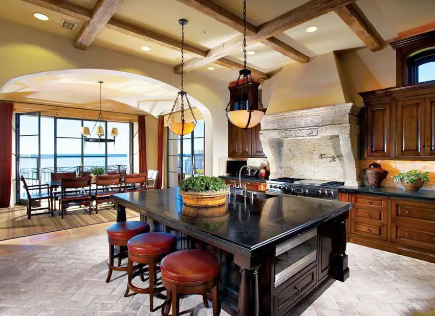 Craftsman kitchen with dark wood cabinetry island and custom stone oven surround