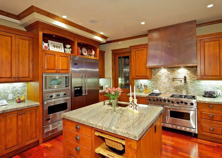 Kitchen with cherry wood plank flooring and custom copper hood