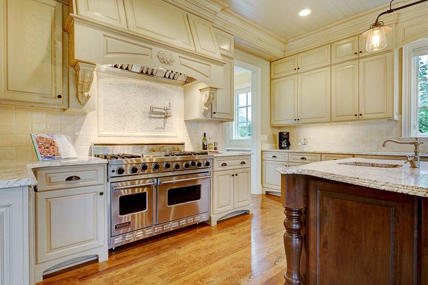 Cream cabinet kitchen with large viking range and island with sink