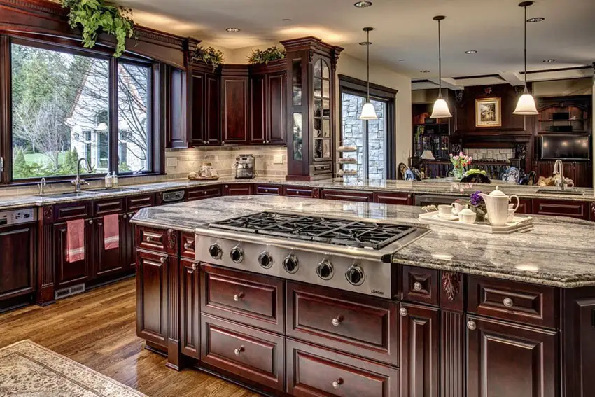 Designer kitchen with stovetop in island and granite countertops