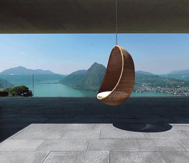Egg hanging chair overlooking waterfront