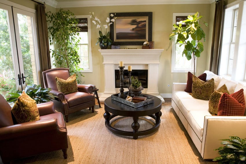 Formal living room with leather chairs, cream sofa and white fireplace with mantel