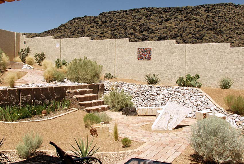 Gravel and brick paver patio in desert landscape backyard