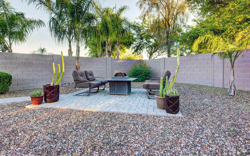 gravel patio with stone paver sitting area and portable fire pit