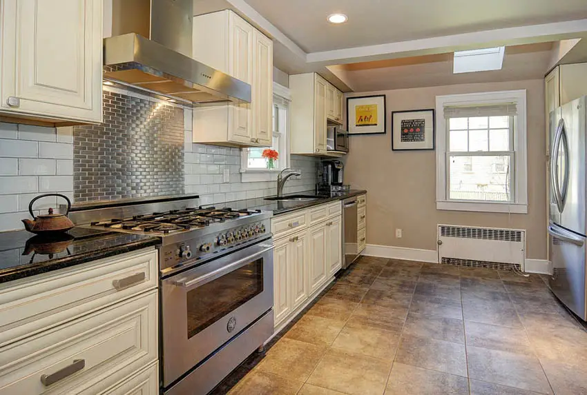 Kitchen with granite counters and stainless steel backsplash