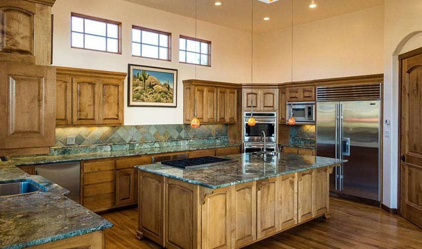 kitchen with emerald green granite countertops and solid wood cabinets