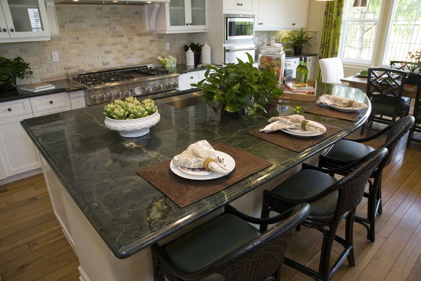 Kitchen with green granite countertops and white cabinets