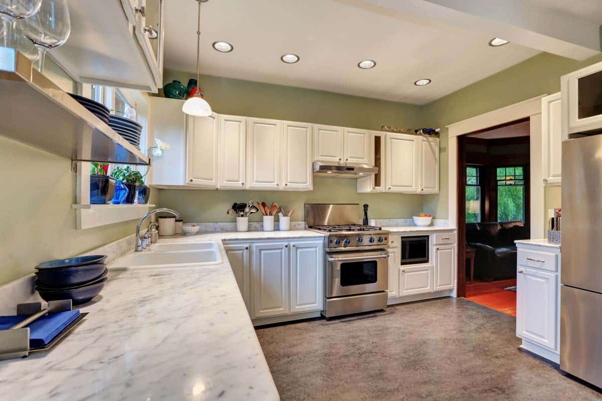 kitchen with white cabinets linoleum flooring countertop and stove