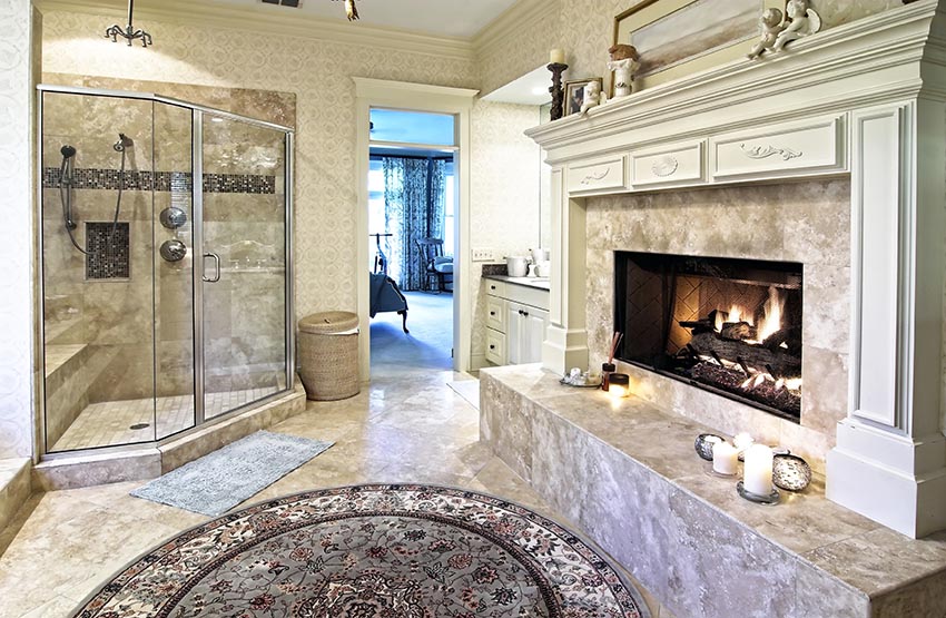 Large bathroom with glass shower with bench and fireplace