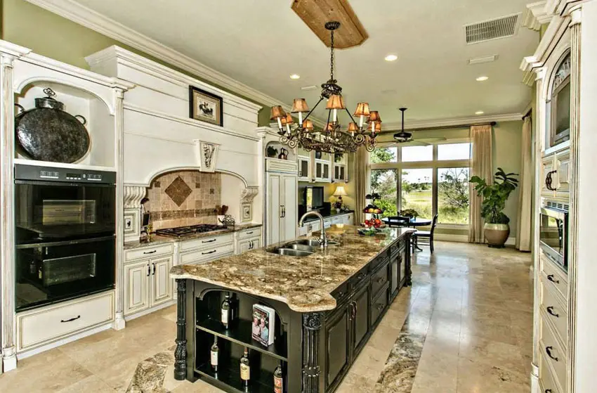 Large traditional kitchen with rectangular island and travertine flooring