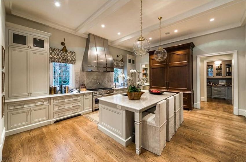 Luxury kitchen with oversized range hood and dining island