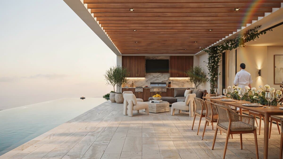 Covered outdoor kitchen with a lounge area and flat screen above the cabinets