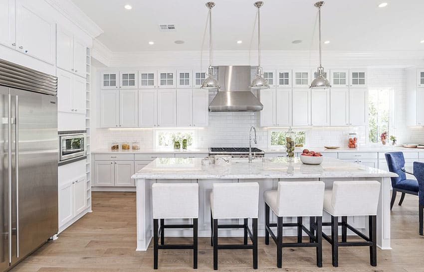 Luxury white cabinet kitchen with calacatta carrara marble countertop breakfast bar