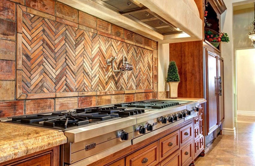 Mediterranean kitchen with viking stovetop and chevron design backsplash