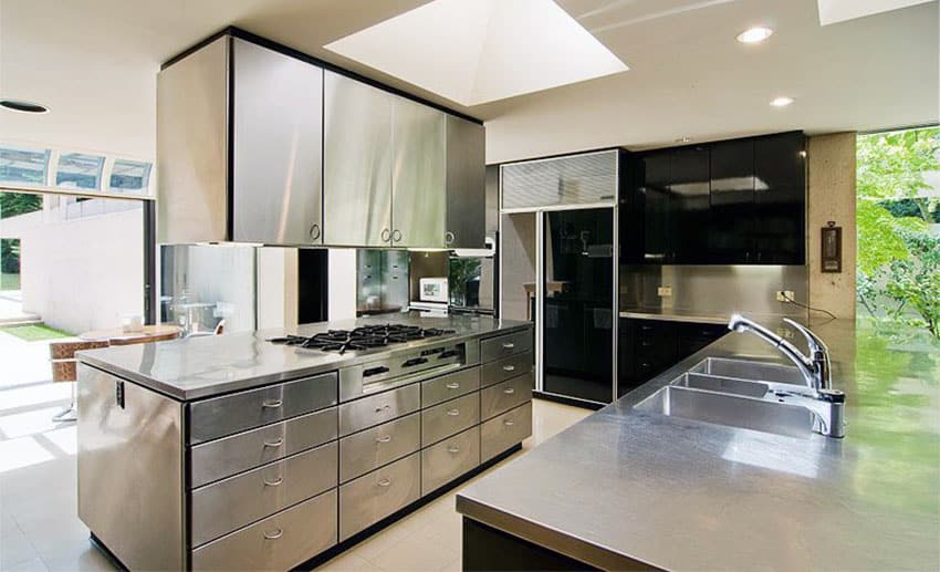 Modern kitchen with stainless steel countertops cabinets and island with cooktop