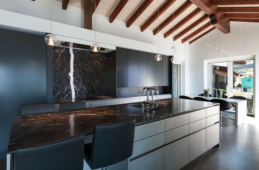 Modern kitchen with two tone cabinets, granite veined counters and backsplash