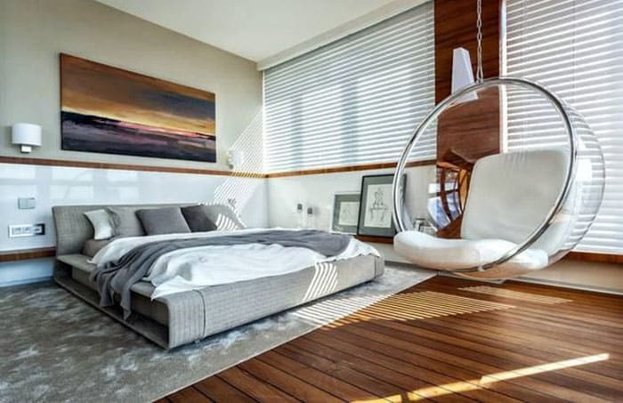 Modern master bedroom with clear cocoon chair