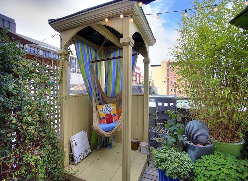 Small backyard gazebo with hanging cocoon hammock reading nook