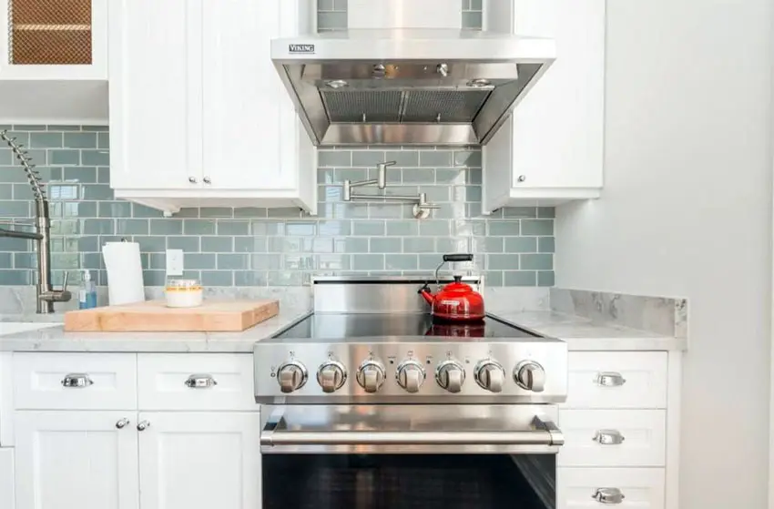 Small cottage kitchen with oven and aqua subway tile