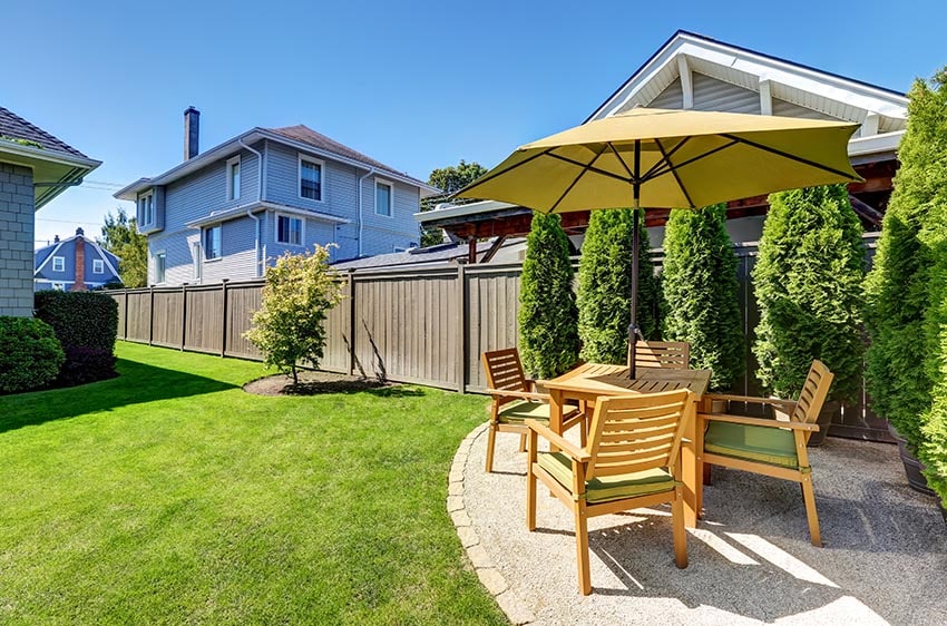 Small patio with wood table set in backyard