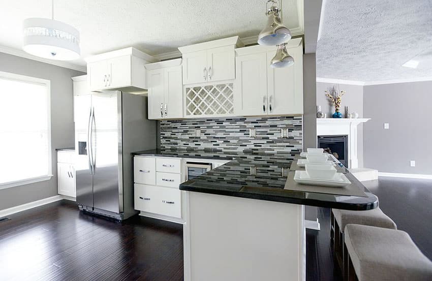 Small l shaped contemporary kitchen with white craftsman panel cabinets and dining peninsula