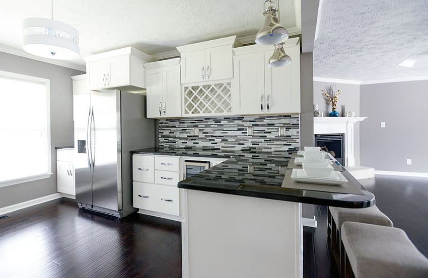 Kitchen with white overhead cabinets, wine holder and dark wengue floors