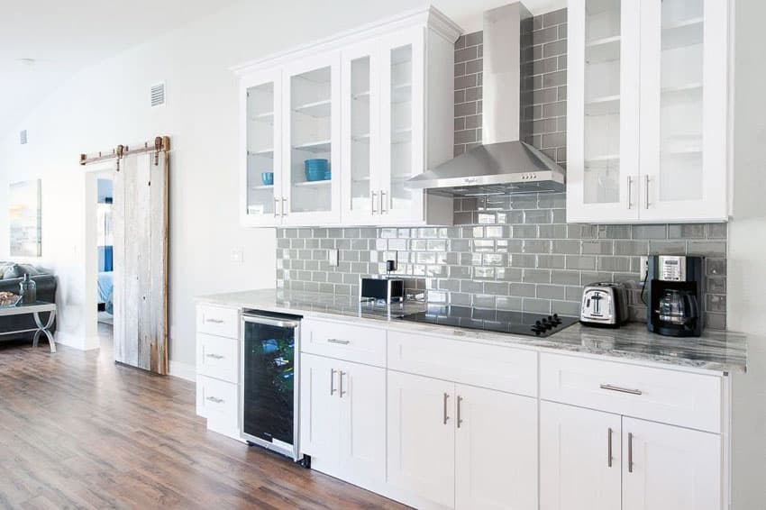 kitchens with white cabinets and backsplashes