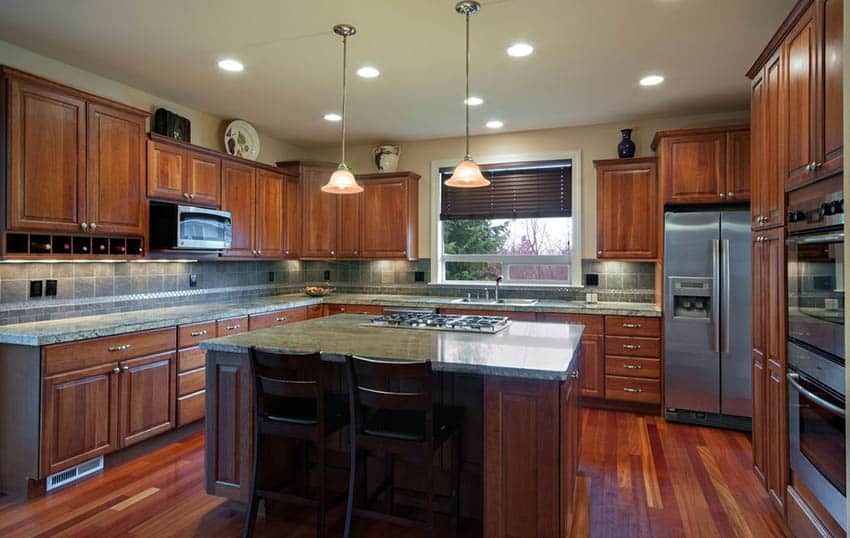 Traditional kitchen with rainforest green granite countertops and cherry cabinets