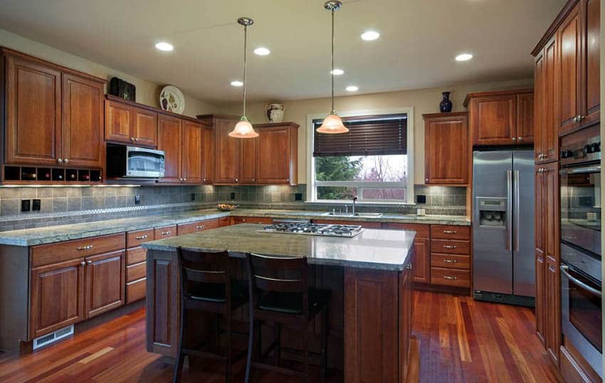 Kitchen with rainforest green granite countertops and cherry cabinets