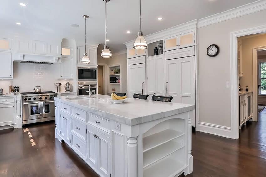 Traditional kitchen with white cabinetry calacatta carrara marble countertop island