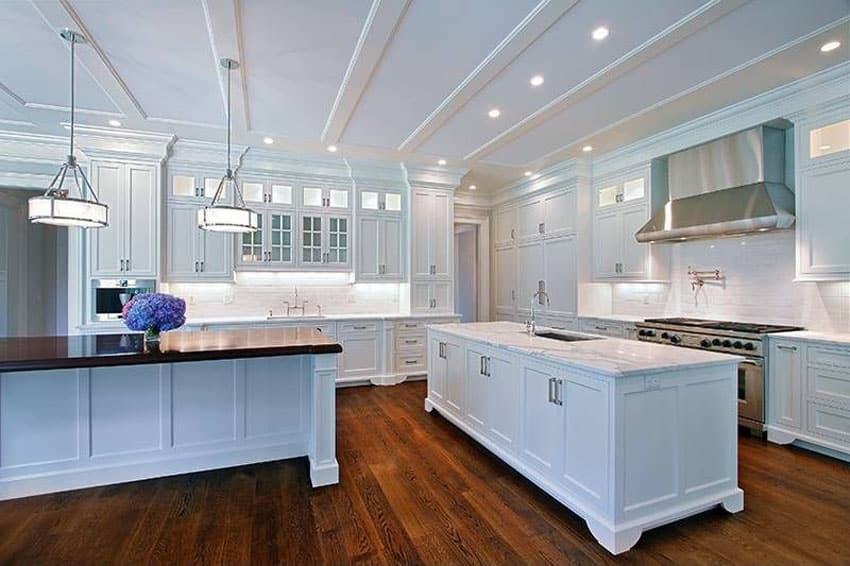 Traditional kitchen with white cabinets hardwood floors and industrial oven