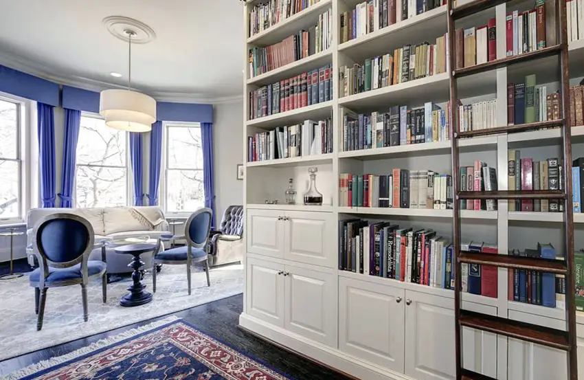 Traditional library with built in bookshelf and attached living room