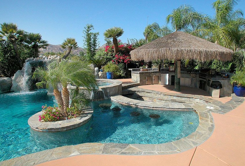 Tropical swimming pool with palapa with outdoor kitchen
