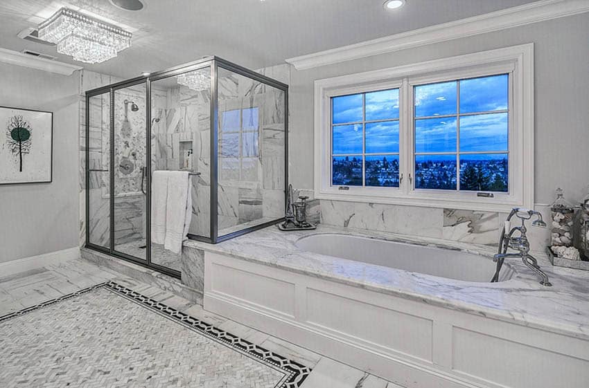 White marble master bathroom with walk in shower and low profile chandelier