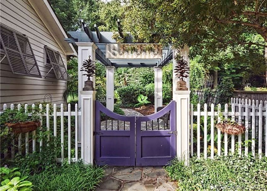 White fence with curved gate and pergola