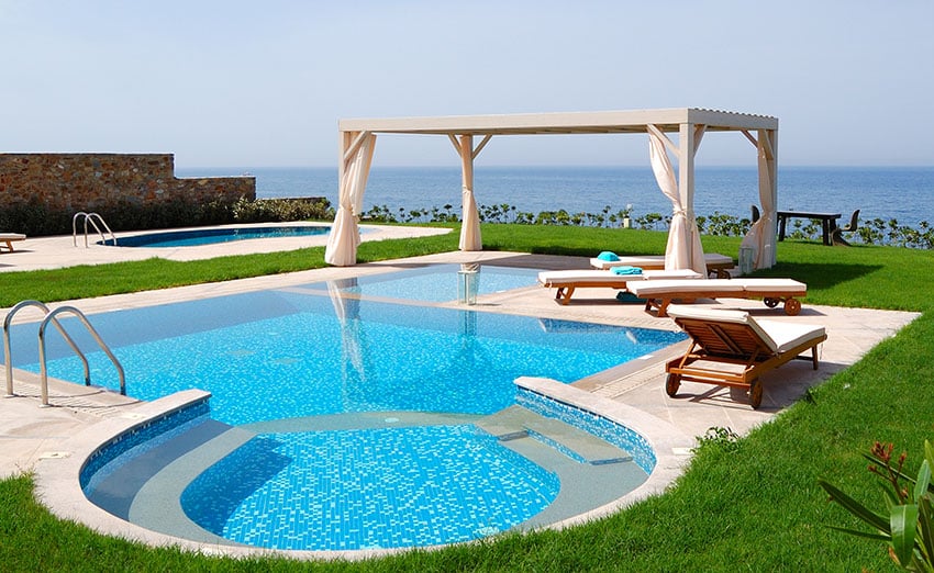 Swimming pool with jacuzzi at the beach of modern luxury villa