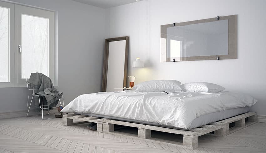Wood pallet bed frame in white bedroom